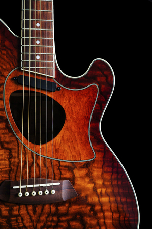 Close up of acoustic guitar, isolated, on black backgroundの写真素材