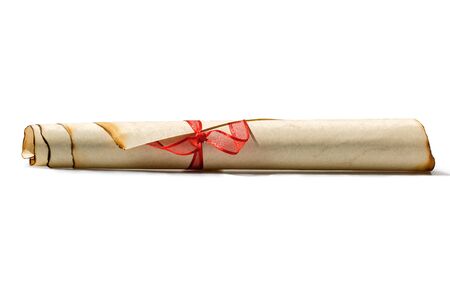 Old brown paper scroll with burned edges tied with red ribbon, on white background, isolatedの写真素材