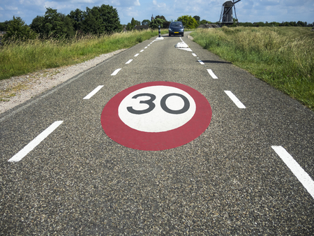 Speed limit sign 30 km/hour marked on the roadの写真素材