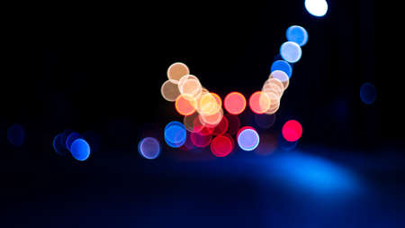 Bokeh lights on road in the city, night lights in city, street lights bokeh background, blur of night lights bokeh on street. Cinematic lens shotの写真素材