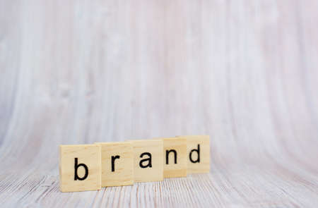 Wooden cubes with word brand on wooden table. Brand building for success conceptの写真素材