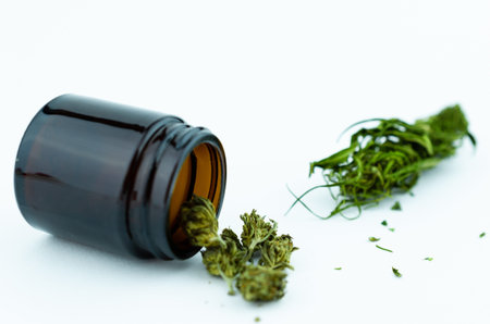 Black glass medical vial of cannabis buds inside. Medical cannabis concept