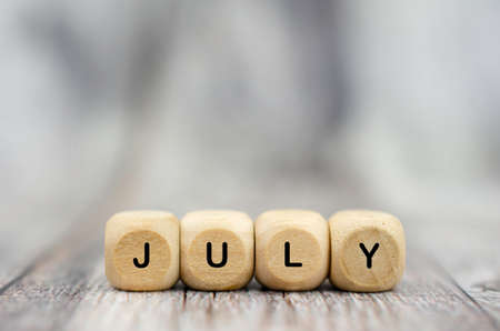 The word July on wooden cubes. Month of yearの写真素材