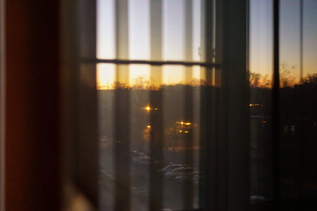 evening sun reflicting of stainless steel microwave oven door closeup