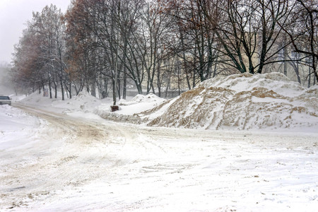 Completely snow-covered city street during a winter snowfallの写真素材