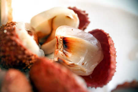 Litchi chinensis. Lychee fruit closeup in the shell, peeled and with pit.の写真素材