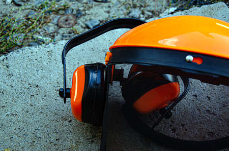 tree surgeon tools on desk including chainsaw, helmet, harness, ear defenders and ropeの写真素材