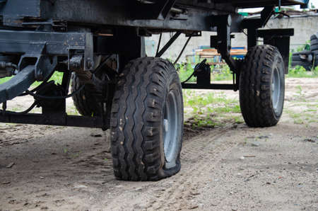 Old rusty tractors flat back tire. industrialの写真素材