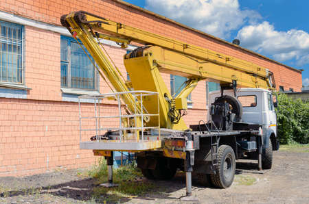Mobile Crane on a road and tower crane in construction siteの写真素材