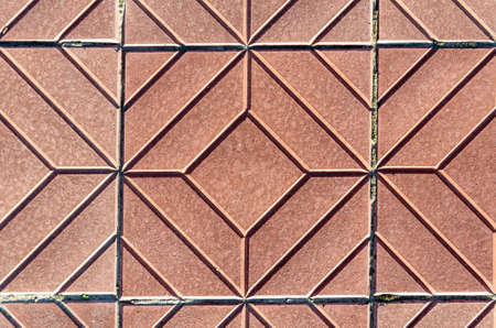 Yellow square-shaped pavement tiles.Beautiful quality texture closeup.Symmetrical pattern.の写真素材