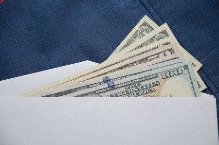 One hundred dollar banknote money in pocket jeans pants background texture. 100 dollar bill close up. Corruption.の写真素材