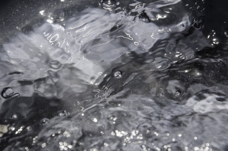 Surface of intensive boiling water with bubbles and swirlsの写真素材