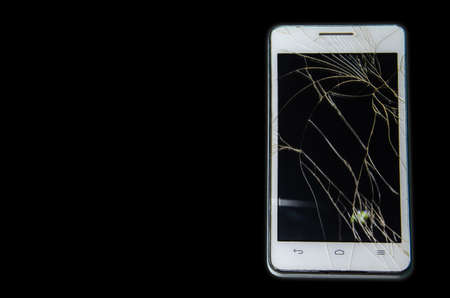 Smartphone with a broken touch screen. Mobile phone broken. The phone crashed. Replacing broken glass on a cell phone. Smartphone repair.の写真素材
