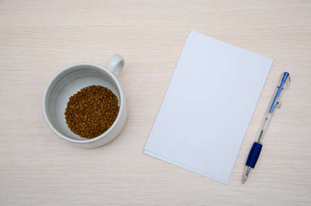 booklet, pencil and coffee cup on wood background. Responsive design mockup.の写真素材