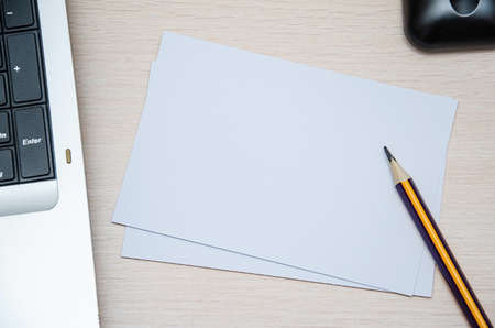 booklet, pencil and coffee cup on wood background. Responsive design mockup.の写真素材