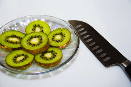 Kiwi fruit cut into pieces cook knifeの写真素材