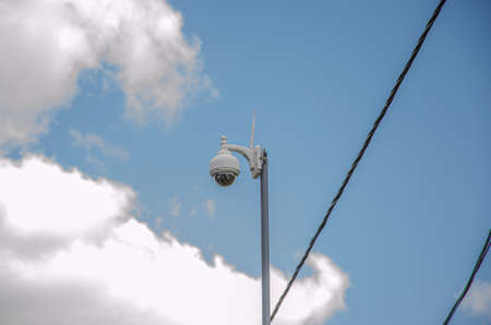 surveillance security camera video equipment on pole outdoor building safety system area control and copy spaceの写真素材