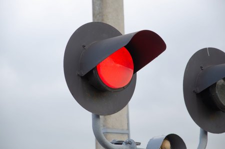 Square Grade crossing signal with red light gate and crossbuck at railroad crossing. Traffic signal...