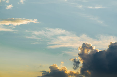 Beautiful evening cloudy sky. Pink warm clouds at the sunset. Colorful background