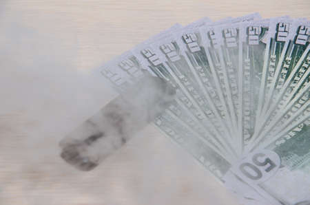 Electronic Vape Pen On Top of a fifty-dollar bill smokeの写真素材