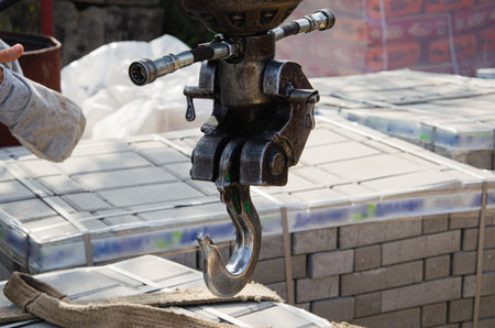 Unloading paving slabs from a truck. Men unload paving slabs using a manipulator.の写真素材