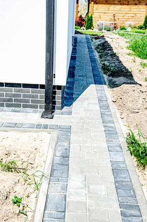 Decorative sturdy concrete tiles for walkways, patios and backyard parking - pavement for the lot outside the house - country house planning and architectureの写真素材