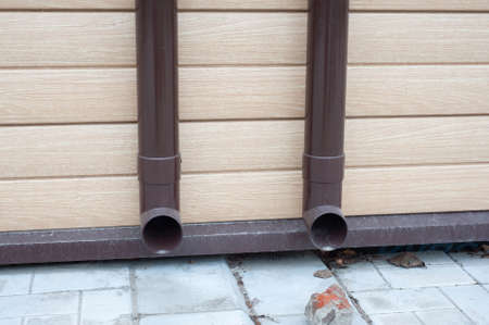 Gutter with downpipe on the roof a house.の写真素材