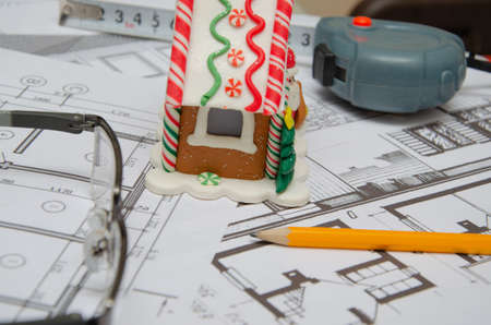 Construction of the building layout, construction financing, packs of dollars, building drawing on paper, drawings rolled in a roll.の写真素材