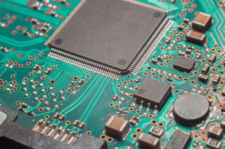 Close-up Macro Shot of Electronic Factory Machine at Work: Printed Circuit Board Being Assembled with Automated Roboticの写真素材