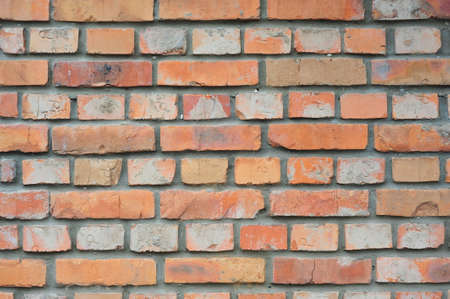 Old brick wall, old texture of red stone blocks closeup retroの写真素材