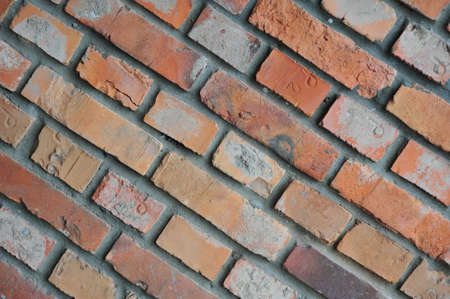 Old brick wall, old texture of red stone blocks closeup retroの写真素材