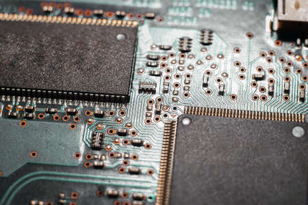 Close-up Macro Shot of Electronic Factory Machine at Work: Printed Circuit Board Being Assembled with Automated Roboticの写真素材