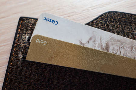 Credit banking cards in leather wallet on wooden backgroundの写真素材