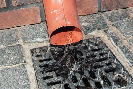 Rain flowing into a storm water sewer system.の写真素材