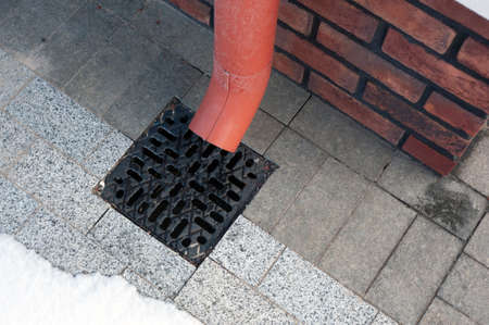 Rain flowing into a storm water sewer system.の写真素材