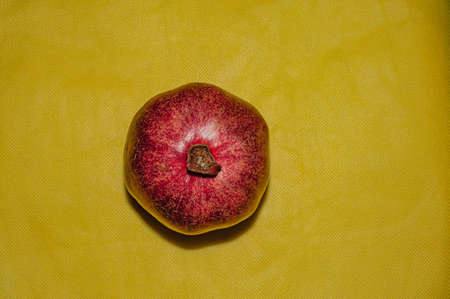 Pomegranate fruit on a yellow background, food redの写真素材