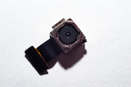 The camera from the smartphone lies on the tablet for repair in the service