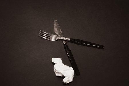 there is a fork with a knife in the form of a cross on a black background. set