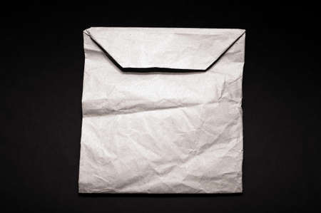 paper bag, crumpled insulated on a black backgroundの写真素材