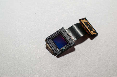 The camera from the smartphone lies on the tablet for repair in the serviceの写真素材