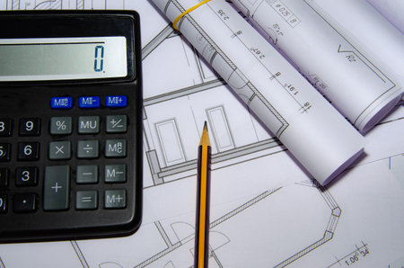 Architect workplace top view. Architectural project, blueprints, blueprint rolls on table. construction background. engineering tools. copy spaceの写真素材