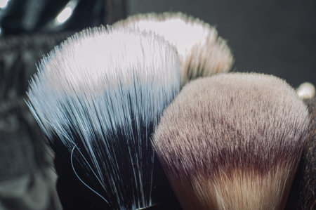Makeup brushes on a black background, with a place to insert text, beautyの写真素材