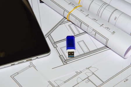 architects work table with technical drawings and tablet computer.の写真素材