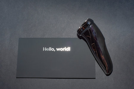 Glossy black electric razor for men on a black background.