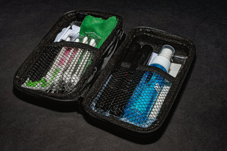 Photographers stuff on black background with lens flash cards lenspen cardrider.
