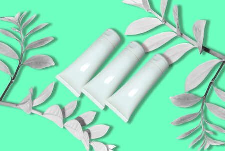 Top view of mockup of white squeeze bottle plastic tube for branding of medicine or cosmetics - cream, gel, skin care, toothpaste. Cosmetic bottle container on a pastel blue background. minimalismの写真素材