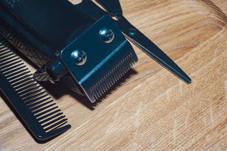 hairdresser electric machine. Shaving machine for barber on wood background. hair trimmer. Home or hair dressing salon hair cut toolsの写真素材