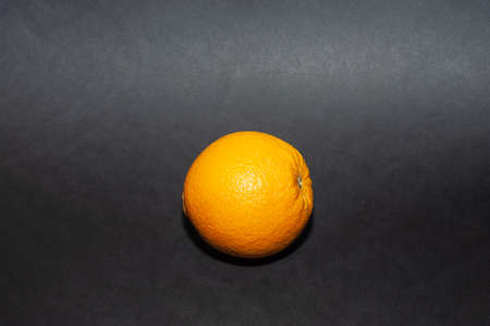 Ripe orange isolated on black backgroundの写真素材