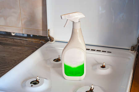 Cleaning product and sponges near plates on gray table, space for text. Dish washing supplies.の写真素材