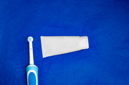 Modern electric toothbrush standing on a white background. Controlled tool for daily oral care.の写真素材